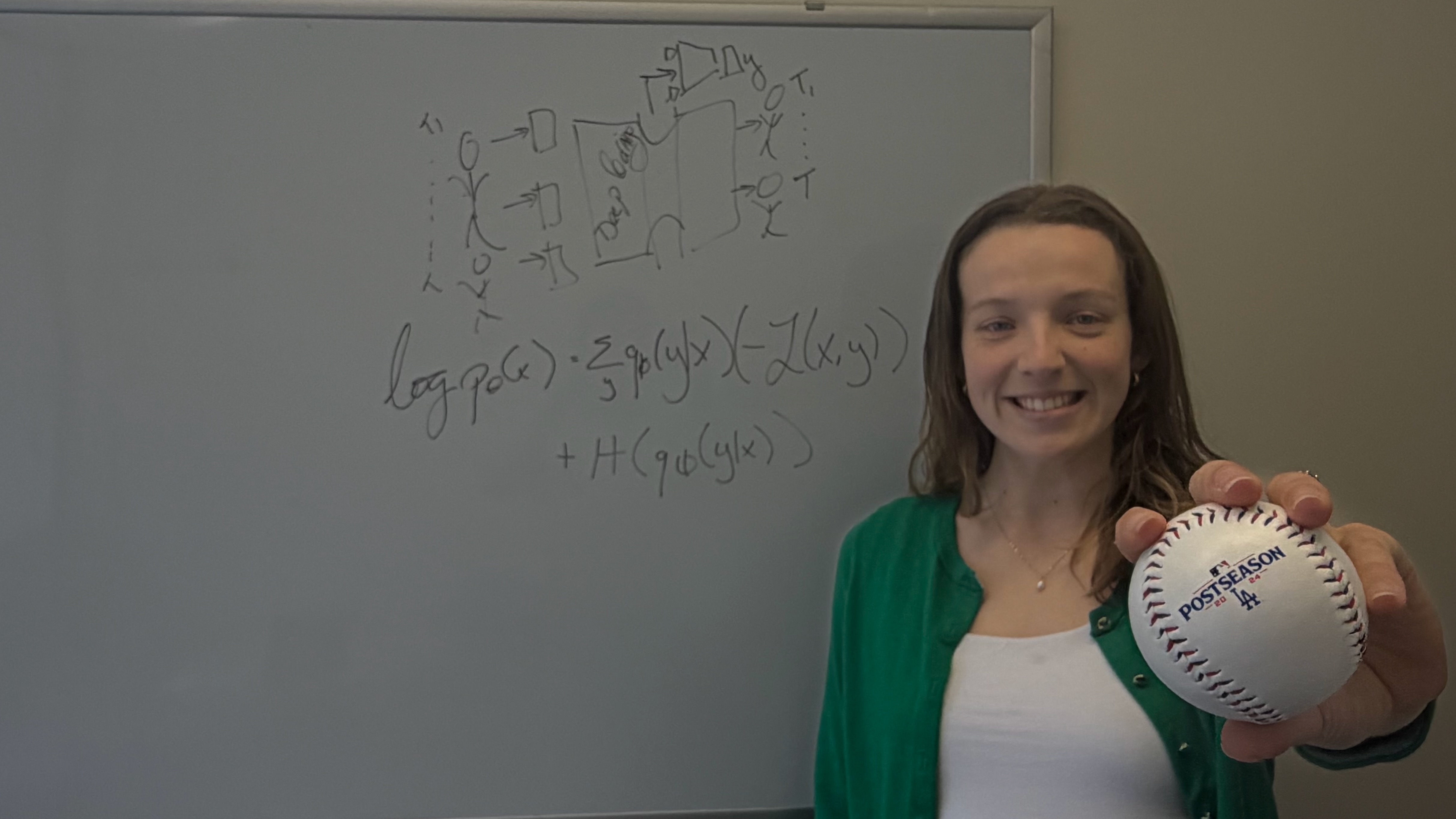 Mathilde Papillon standing in front of a whiteboard with mathematical diagrams, smiling and holding a Los Angeles Dodgers baseball toward the camera. Caption: Mathilde Papillon, a Ph.D. candidate in the Geometric Intelligence Lab at UC Santa Barbara, serves as an AI Research Scientist for the Los Angeles Dodgers.