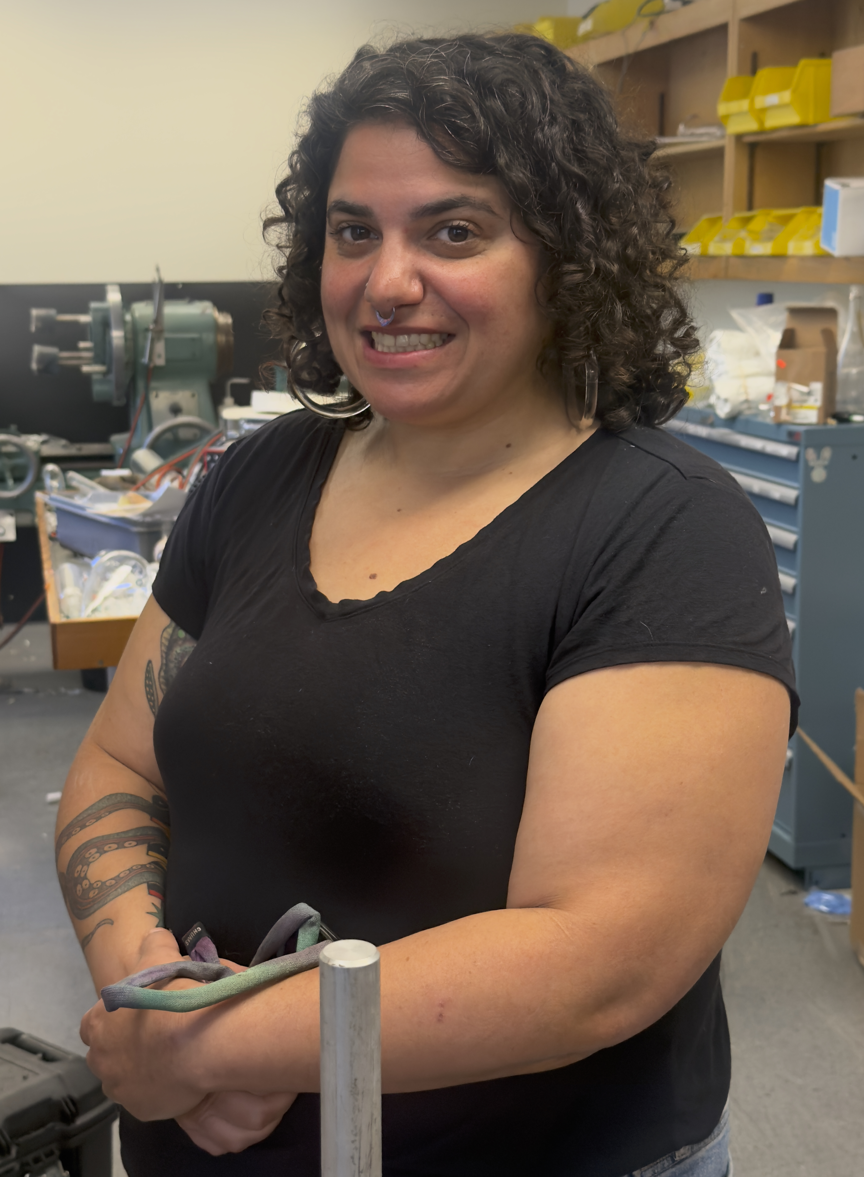 Portrait of Corina Guerra standing in the Chemistry and Biochemistry Glass Shop.